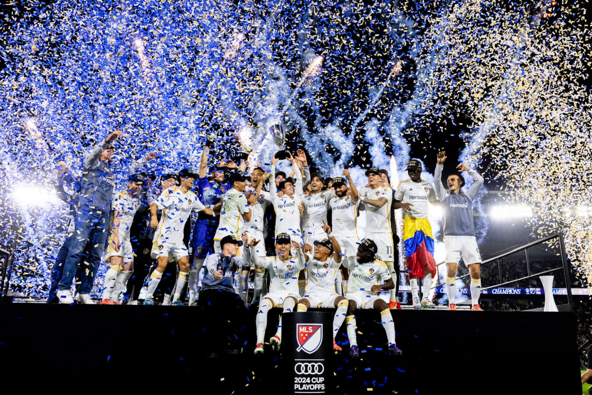 Riqui Puig lifts the trophy with LA Galaxy teammates after his ACL tear.