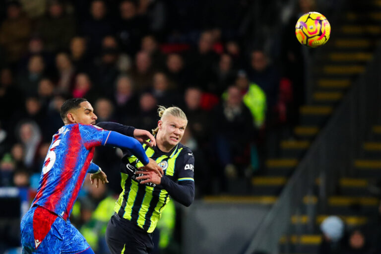 Manchester City struggling as striker Erling Haaland challenges for ball