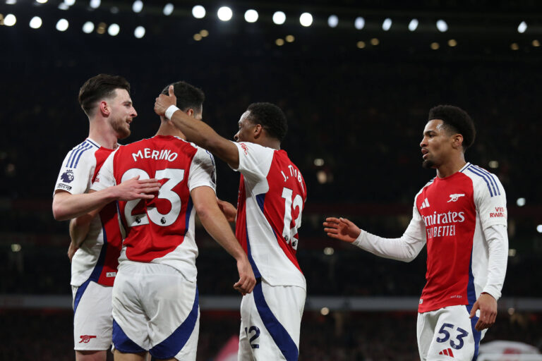 Arsenal players celebrate with Mikel Merino